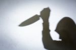 Male Hand Shadow With Knife Stock Photo