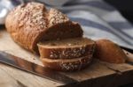 Dark Multigrain Bread Whole Grain Fresh Baked On Rustic Closeup Stock Photo