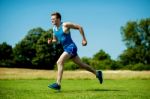 Fit Athlete Running Hard On A Sunny Day Stock Photo