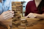 Business Man Placing Wooden Block On A Tower Concept Of Risk Con Stock Photo