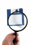 Magnifying Glass On Floppy Disk Stock Photo