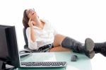 Pleased Woman Sitting In Office Stock Photo