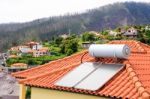 Water Boiler With Solar Panels On Roof Of House Stock Photo