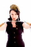 Young Woman Wearing Army Cap And Holding Nunchaku In Anger Stock Photo
