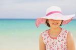Happy Child Relaxing On The Beach Against Sea And Sky Background Stock Photo