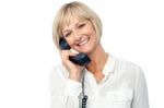 Smiling Woman Holding Phone Receiver Stock Photo