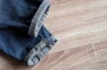 Close Up Of Fold Selvedge Denim Jeans On Wooden Background With Stock Photo