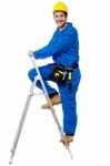 Construction Worker Climbing Up The Step Ladder Stock Photo