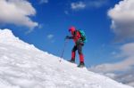 The Man In The Winter Journey With A Backpack On The Background Of Mountains Stock Photo