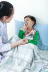 Asian Boy Having Respiratory Illness Helped By Health Professional In Hospital Stock Photo