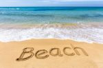 Word Beach Written In Sand At Greek Sea Stock Photo