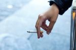 Womans Hand With Cigarette In The Street Stock Photo