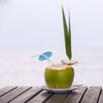 Coconut Water Drink Served In Coconut With Drinking Straw On The Stock Photo