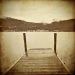 Tranquil Scene Of Old Wooden Pier And Misty Italian Alps Mountai Stock Photo