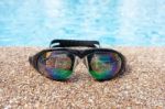 Glasses For Swimming On A Cement Floor With Small Stone Near Swi Stock Photo