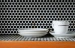 Clean Plates And Cups On Grunge Metal Grill Pattern Stock Photo