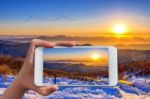 Hand Holding Smart Phone Take A Photo At Sunrise On Deogyusan Mountains In Winter Stock Photo