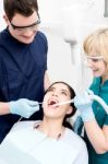 Dentist Examining A Woman Teeth Stock Photo
