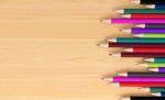 Colored Pencils On Wooden Board Stock Photo