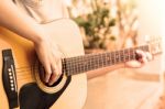 Woman's Hands Playing Acoustic Guitar With Vintage Style Stock Photo