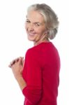Aged Woman Looking Over Her Shoulders Stock Photo