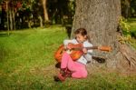 Pretty  Little Girl Playing Guitare In The Park Stock Photo