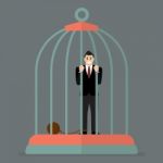 Businessman With Weight In Bird Cage Stock Photo