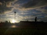 Silhouette  Running On Road At Sunrise Stock Photo