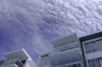 Low Rise Modern Architecture In Blue Cloud Sky Stock Photo