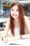 Portrait Of Thai Adult Beautiful Girl Write A Book And Smile In University Stock Photo