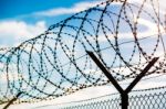 Fence With Barbed Wire Stock Photo