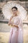 Beautiful Thai Woman Wearing Old Thai Tradition Clothes Style Holding Bamboo Wood Umbrella With Toothy Smiling Face Stock Photo