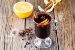 Mulled Wine And Spices On Weathered Wooden Table Stock Photo