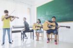 Group Of Happy Asian Kids Or Students Playing Musical Instruments In School Stock Photo