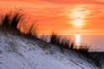 Orange Sunset With Dune And Sea Stock Photo