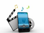 Mobile Phone , Music Symbols, And Clapperboard With Reels Of Fil Stock Photo