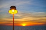 Lighting Of Warm Lamp And Lighting Of Sunset At Sea Stock Photo