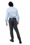 Young Businessman In Walking Posture Stock Photo