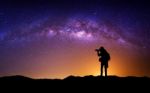 Silhouette Of Photographer With Camera And Milky Way Blackground Stock Photo