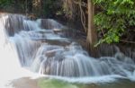 Waterfall Flowing From Tthe Water Flowing Over Rocks And Trees Down A Waterfall At Huay Mae Khamin Waterfall National Park ,kanchana Buri In Thailand.he Mountains At Huay Mae Khamin Waterfal Stock Photo