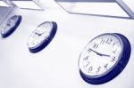 Wall Clocks Showing Different Time Stock Photo