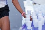 Marathon Racer Catching Cup Of Water Stock Photo