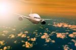 Passenger  Plane Flying Over Beautiful Light Sky For Air Traveling Theme Stock Photo