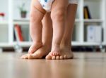 Mother And Baby Legs. First Steps Stock Photo