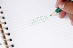 Write The Word Green With Green Pencil In Blur Man's Hands Stock Photo