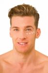 Young Man With Anti Wrinkle Cream Stock Photo