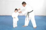 Black Belt Karate Teaching A Little Girl Stock Photo