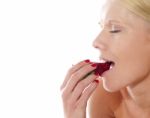 Caucasian Lady tasting Strawberry Stock Photo