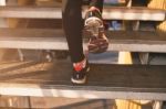 Close Up Of Feet With Sneakers Climbing Up The Stairs Stock Photo