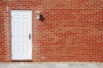 White Door On A Brick Wall Stock Photo